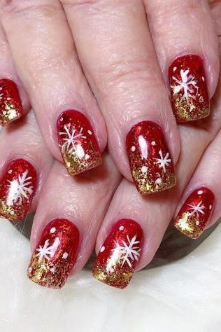 Red with white snowflake and gold glitter fade, mature hands - Christmas nail design for older women