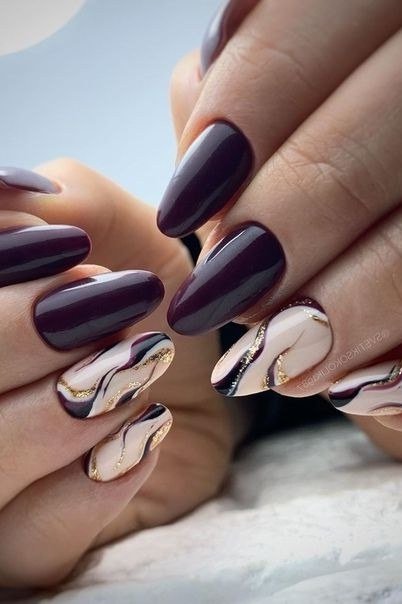 Burgundy nails with marble and cream accent nails for women over 50
