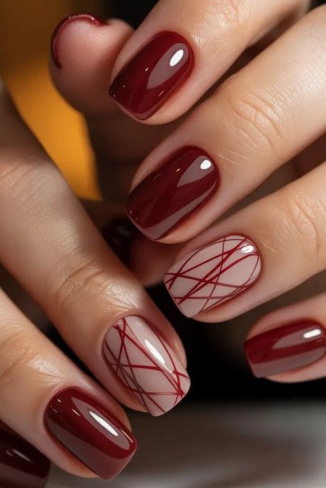 52. Oxblood Nails With Geometric Line Art - Thanksgiving nail art idea for women over 50