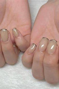 nude nails with gold rim accent