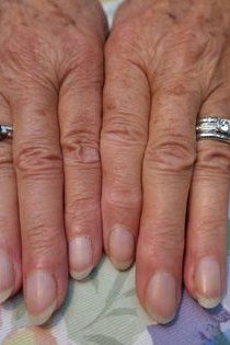 Buffing natural mature nails lightly for shine