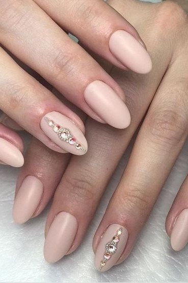 Nude almond nails with rhinestone accent
