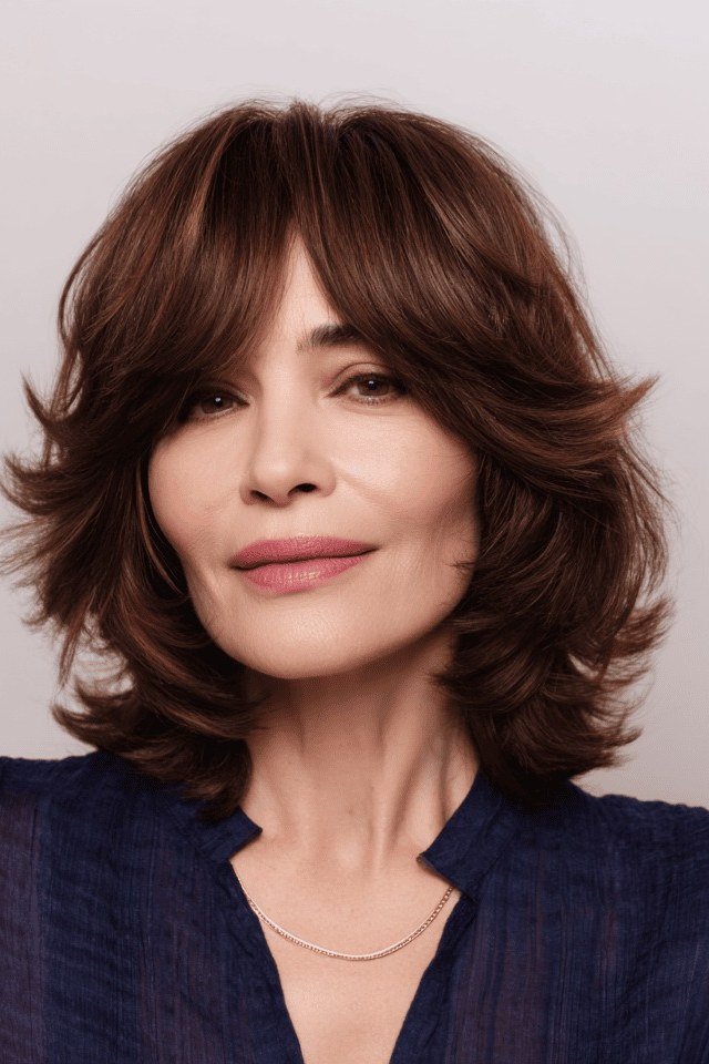 Polished dark wavy bob with bangs and tousled texture for women over 40