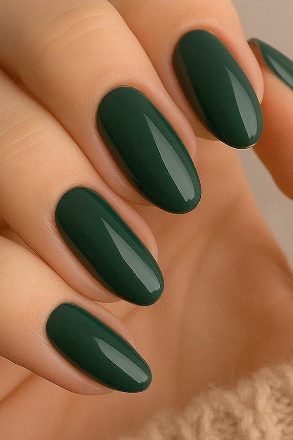 Forest green glossy almond gel nails, deep fall green manicure for women over 50