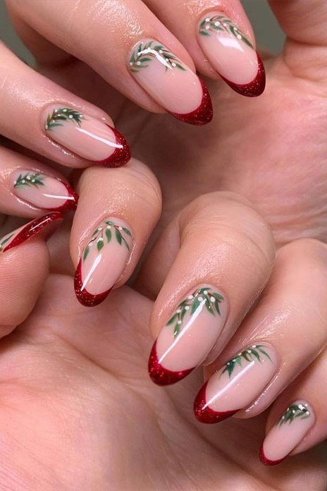 nude nails with red tips and pine sprig christmas art
