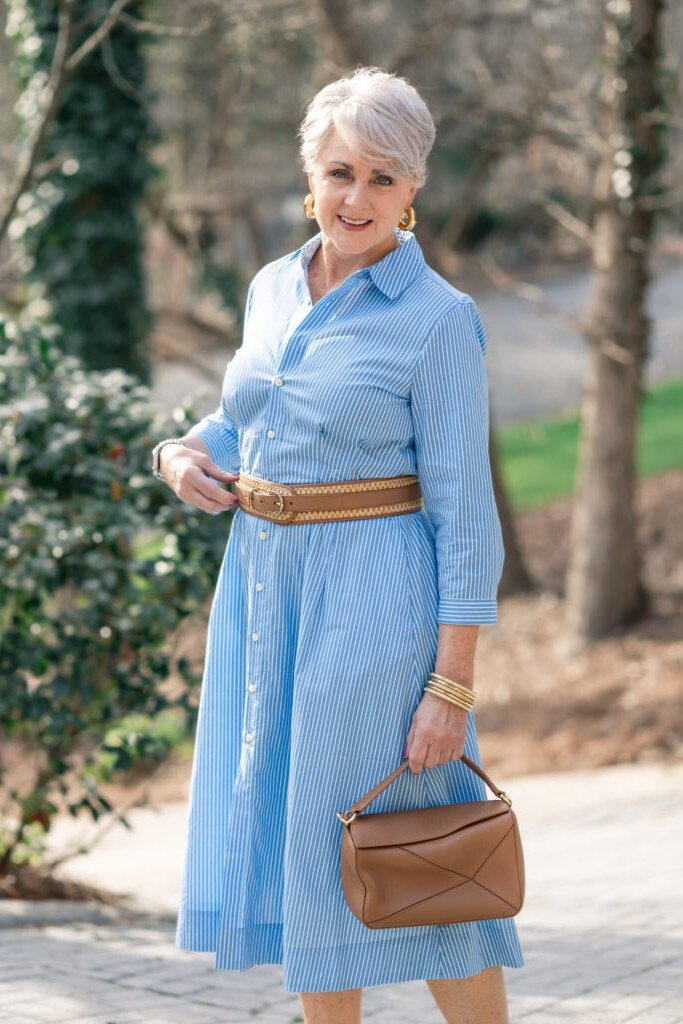 Easy casual outfit idea for women over 50: light blue shirtdress and tan belt, older woman everyday style