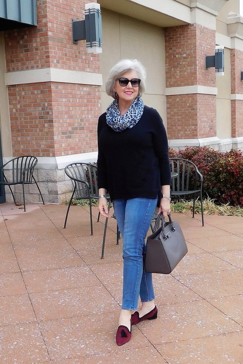 black sweater, patterned scarf and burgundy flats fall outfit for women over 60
