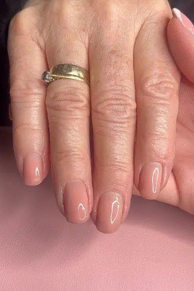 Glossy nude pink mature hands nails for women over 50