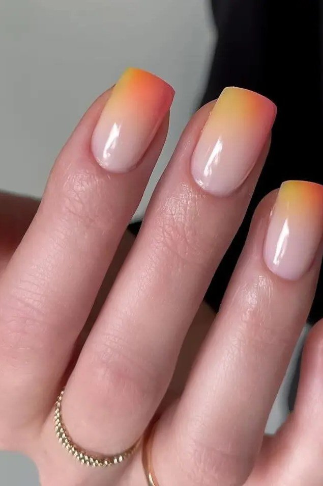 Nude to Orange Almond Ombre - A sheer nude base fades into soft tangerine tips on these medium almond nails with a clean glossy finish.