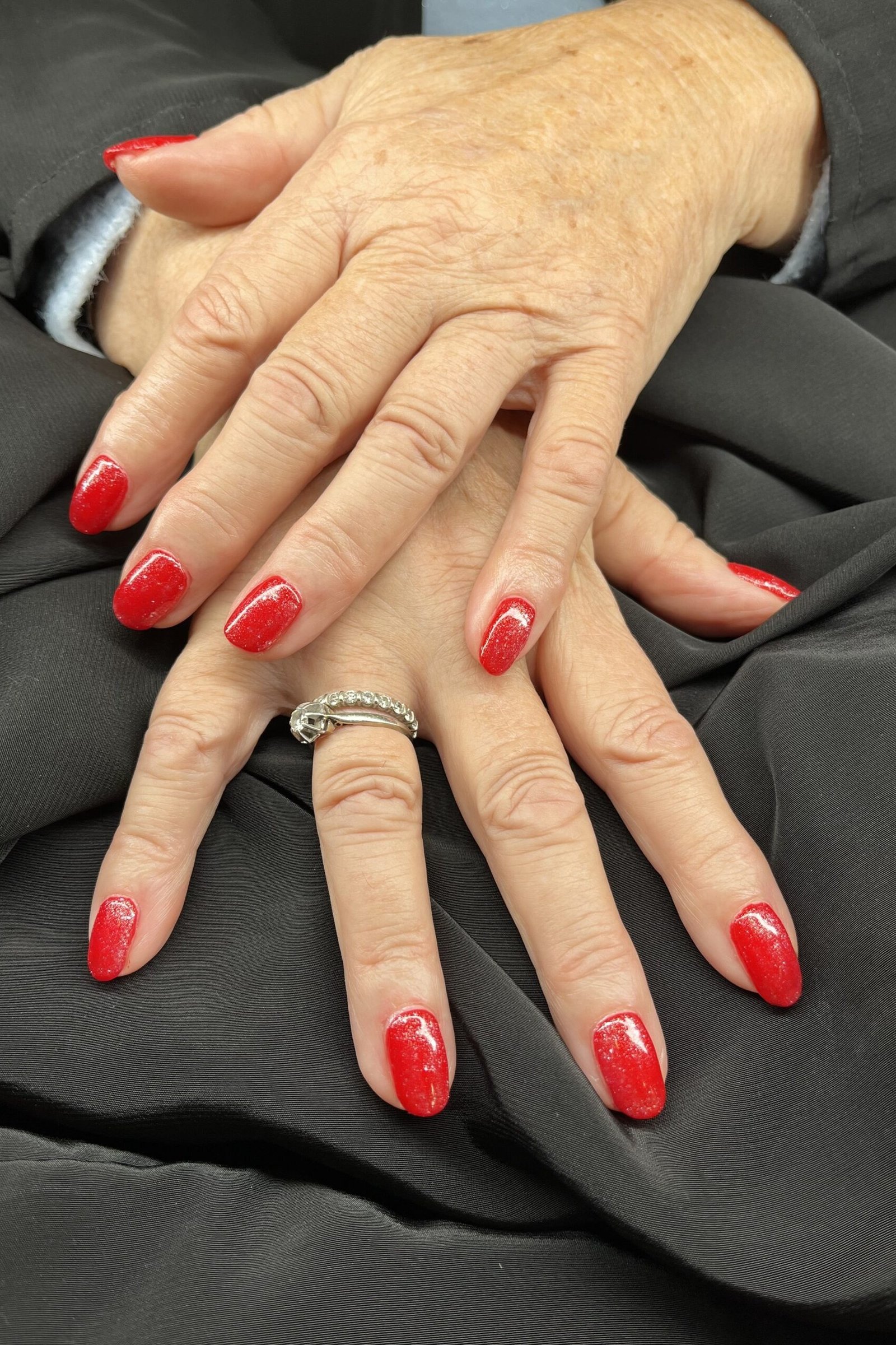 classic red on mature hands, dark blouse