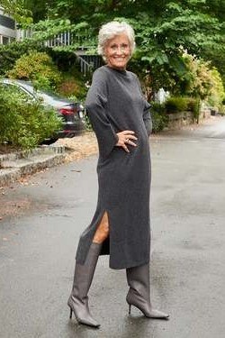 Grey side-slit turtleneck sweater dress with grey boots on street, cozy sweater outfit idea for women over 70