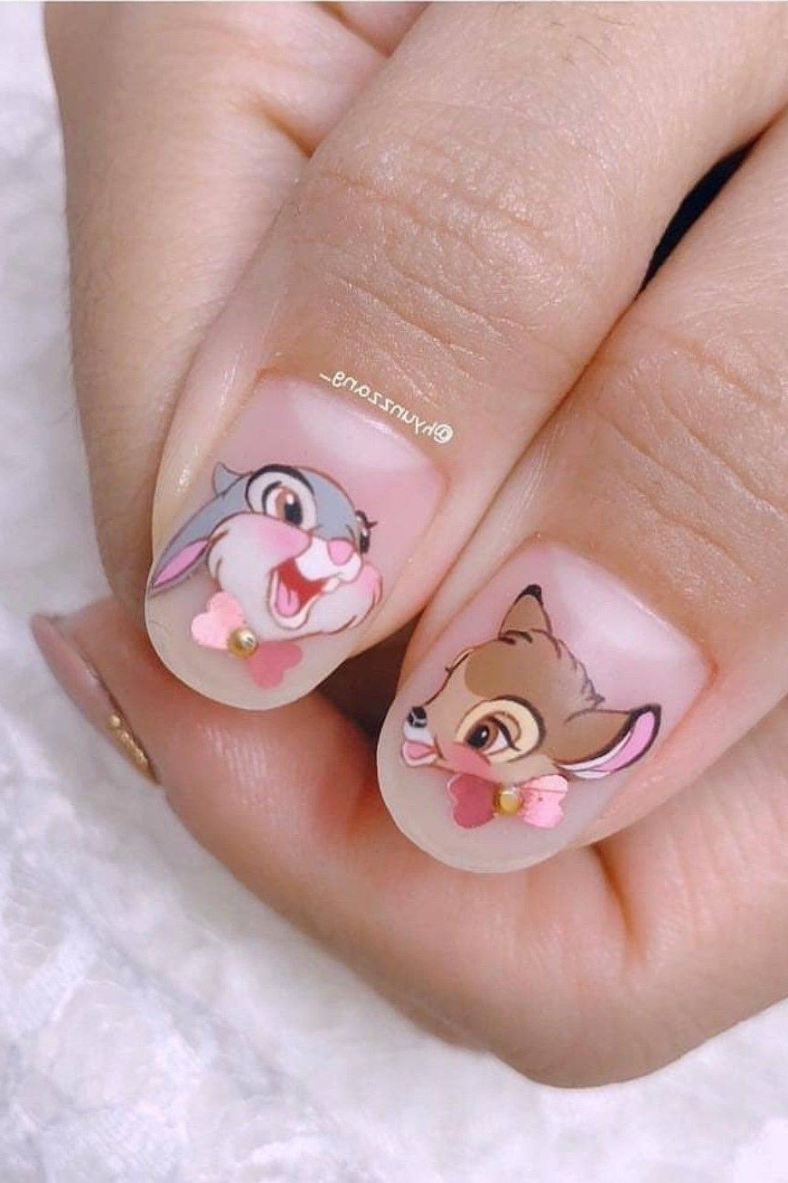 Short round nails with Bambi and Thumper portraits and pearls