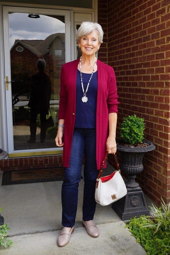 Red knit cardigan with a navy top and navy trousers, colorful weekend outfit for women over 40