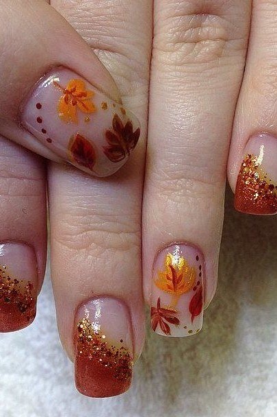 Sheer nails with maple leaf and glitter on mature hands, fall nail design for older women