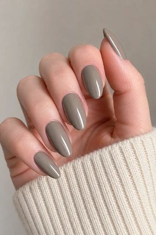 Grey taupe almond nails with sweater, sophisticated nail design for women over 50