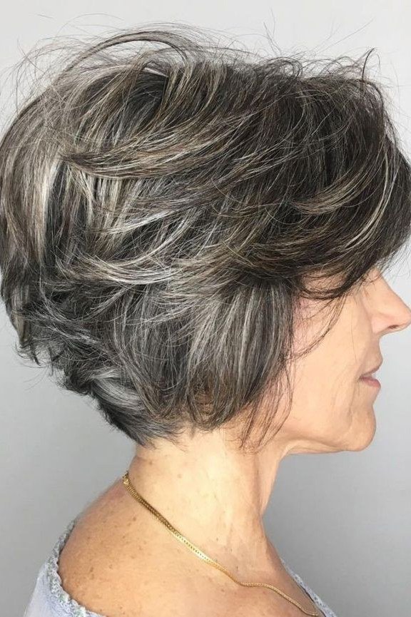Dark salt-and-pepper stacked shaggy bob for women over 60, side profile