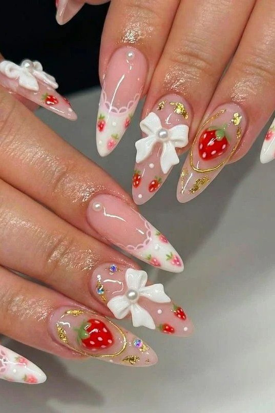 Long almond nails with 3D bows and strawberry art
