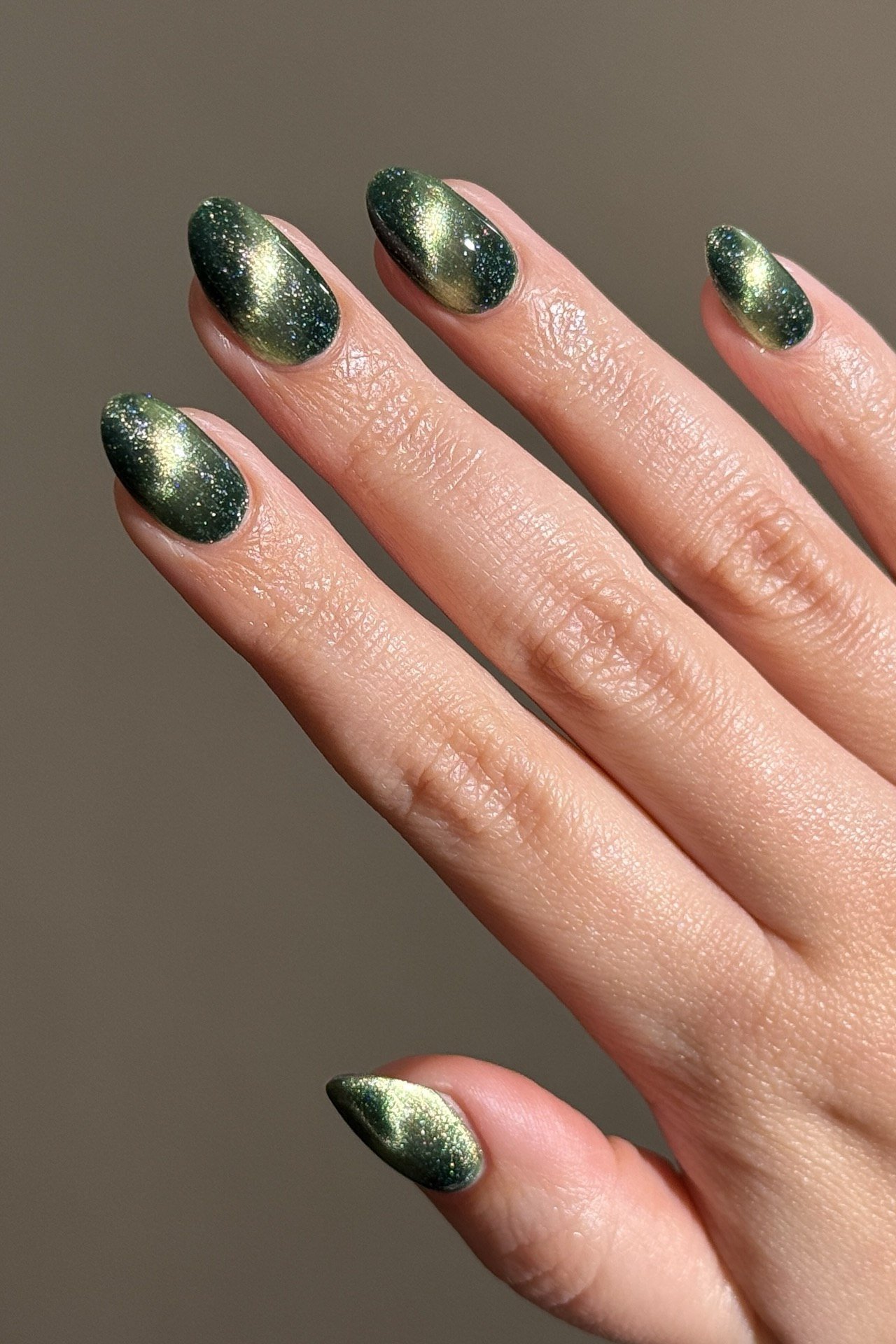 Dark Green Glitter Cat Eye Nails - Dark forest green with sparkling glitter and magnetic shimmer glows in this close view.