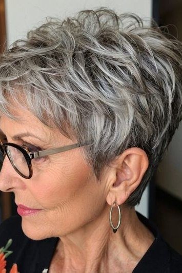White spiky pixie with glasses, three-quarter view, micro pixie cut for women over 60 going silver
