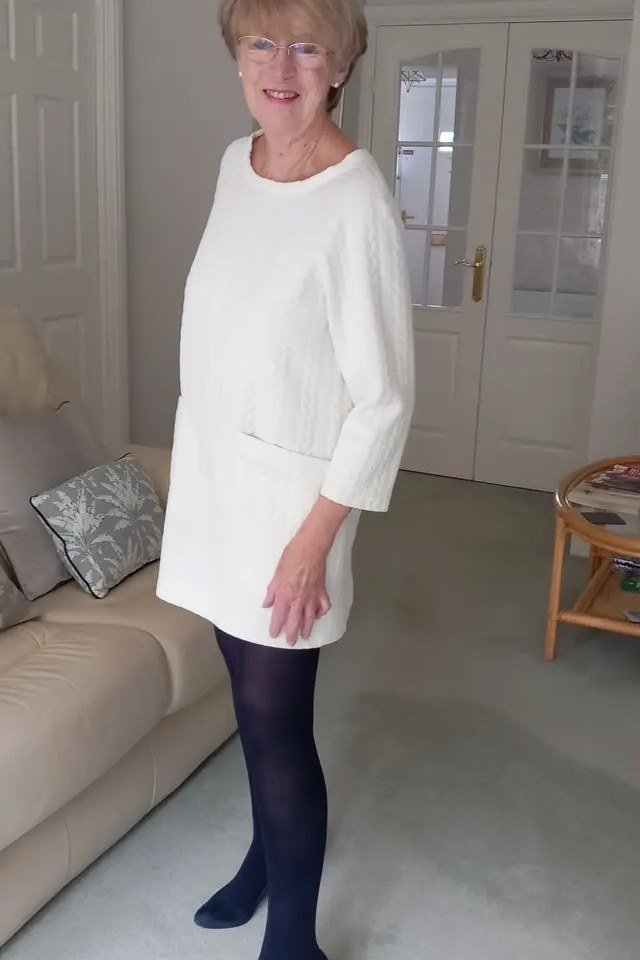 white knit tunic dress with dark tights for women over 60