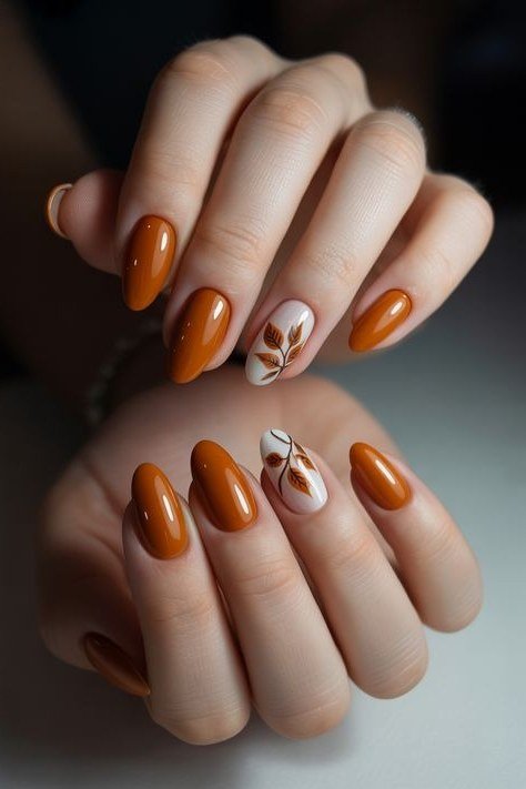 Burnt orange with leaf art short almond, elegant fall nail design for women over 40