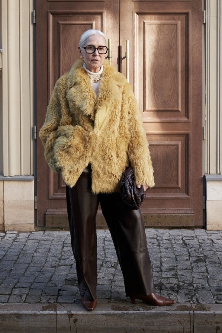 golden faux fur coat with dark brown pants church outfit for women over 60
