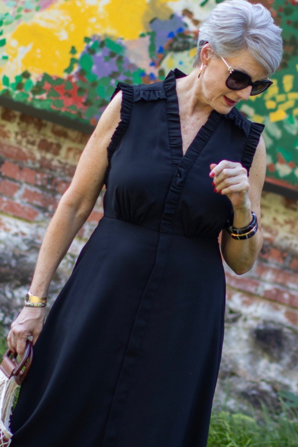 Black sleeveless button-front midi dress for women over 50
