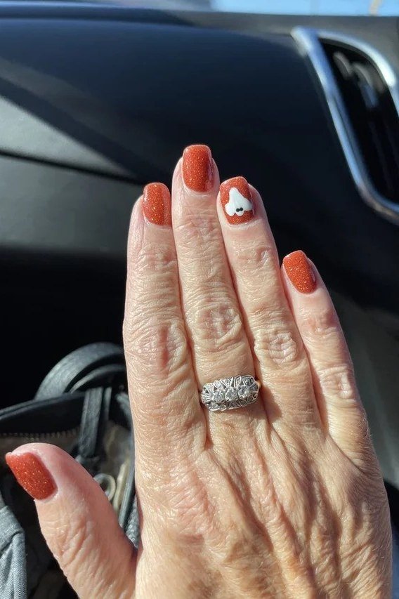 Burnt Orange with Pumpkin Art - fall nail color idea for women over 60