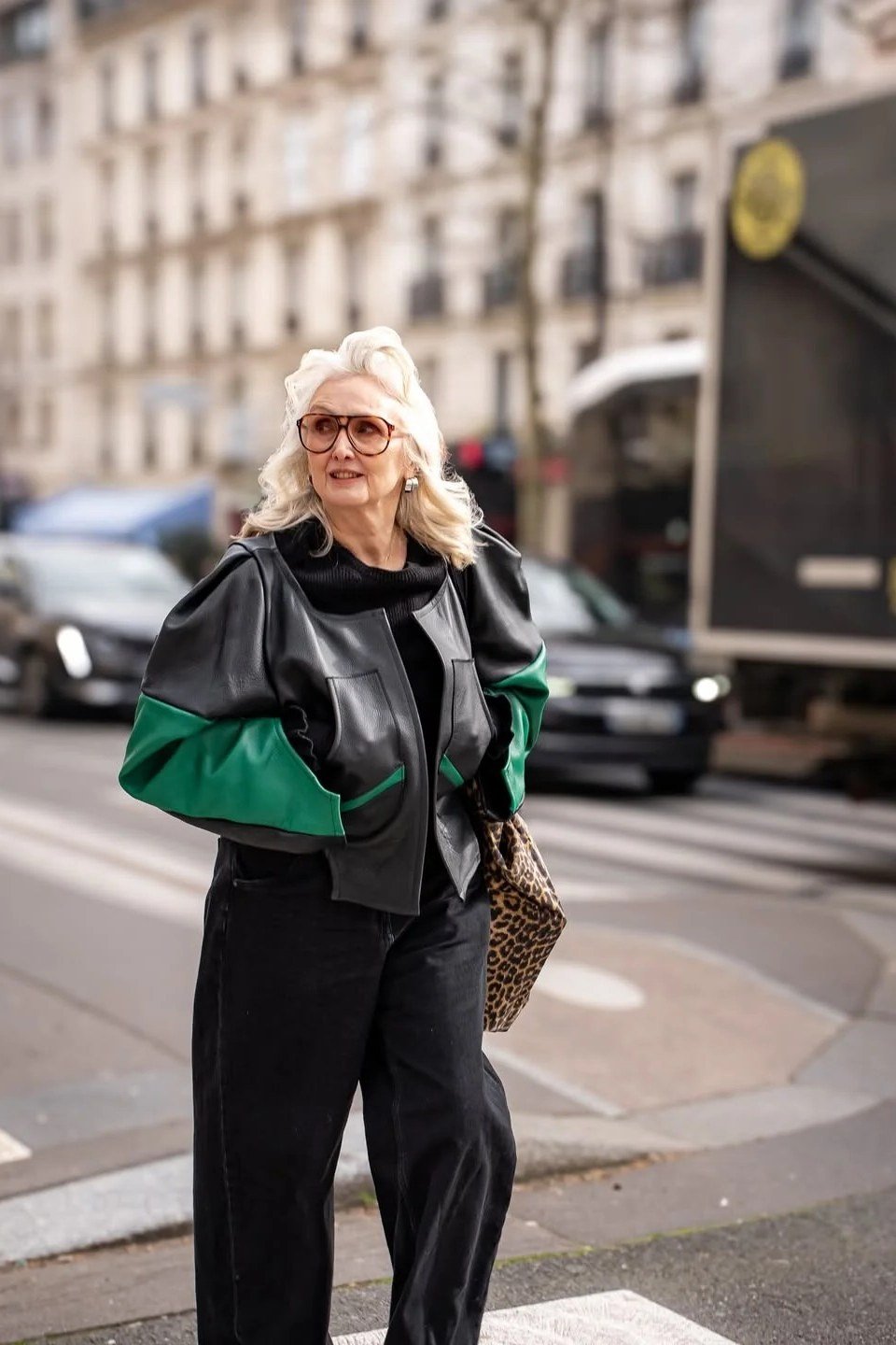 Fall city outfit for women over 50: black leather jacket green lining black trousers