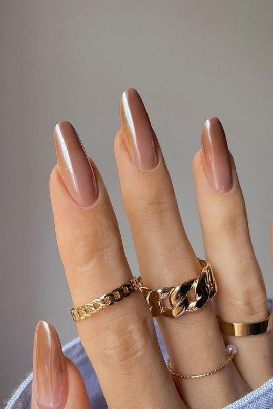 Bronze Nude Coffin Ombre - Warm bronze fades into soft nude on these medium coffin nails, styled with gold jewelry.