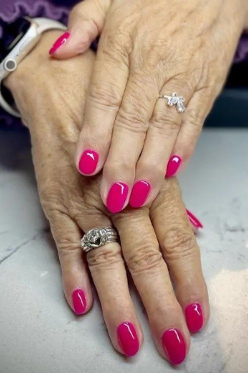 bright pink on mature hands, smartwatch
