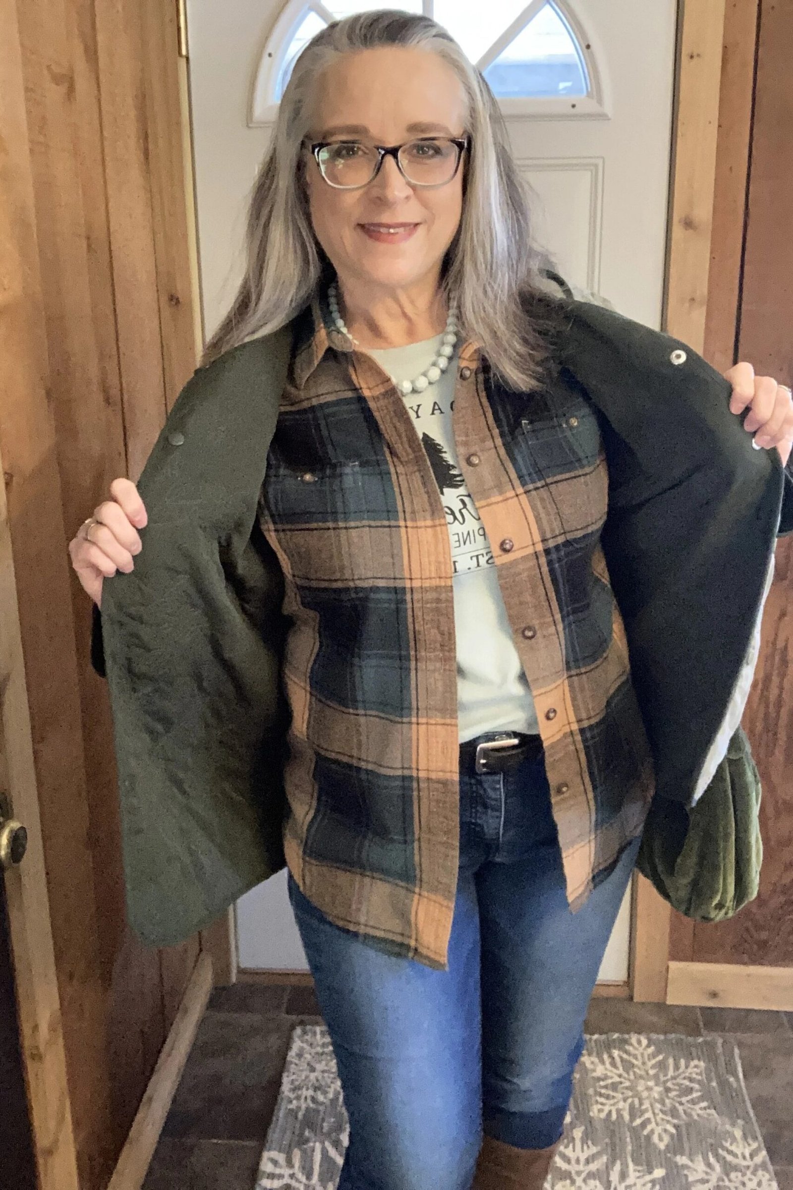 Olive shacket over plaid flannel shirt with blue jeans