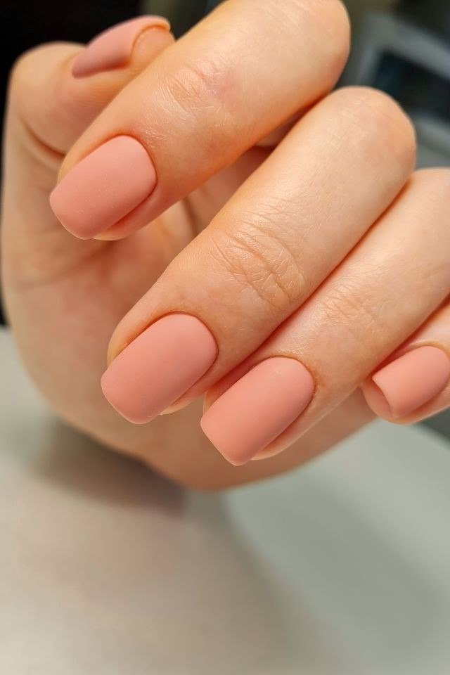 Peach nude nails in fist pose