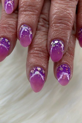 Purple glitter ombre on mature hands, short nails, ombre nail design for women over 60