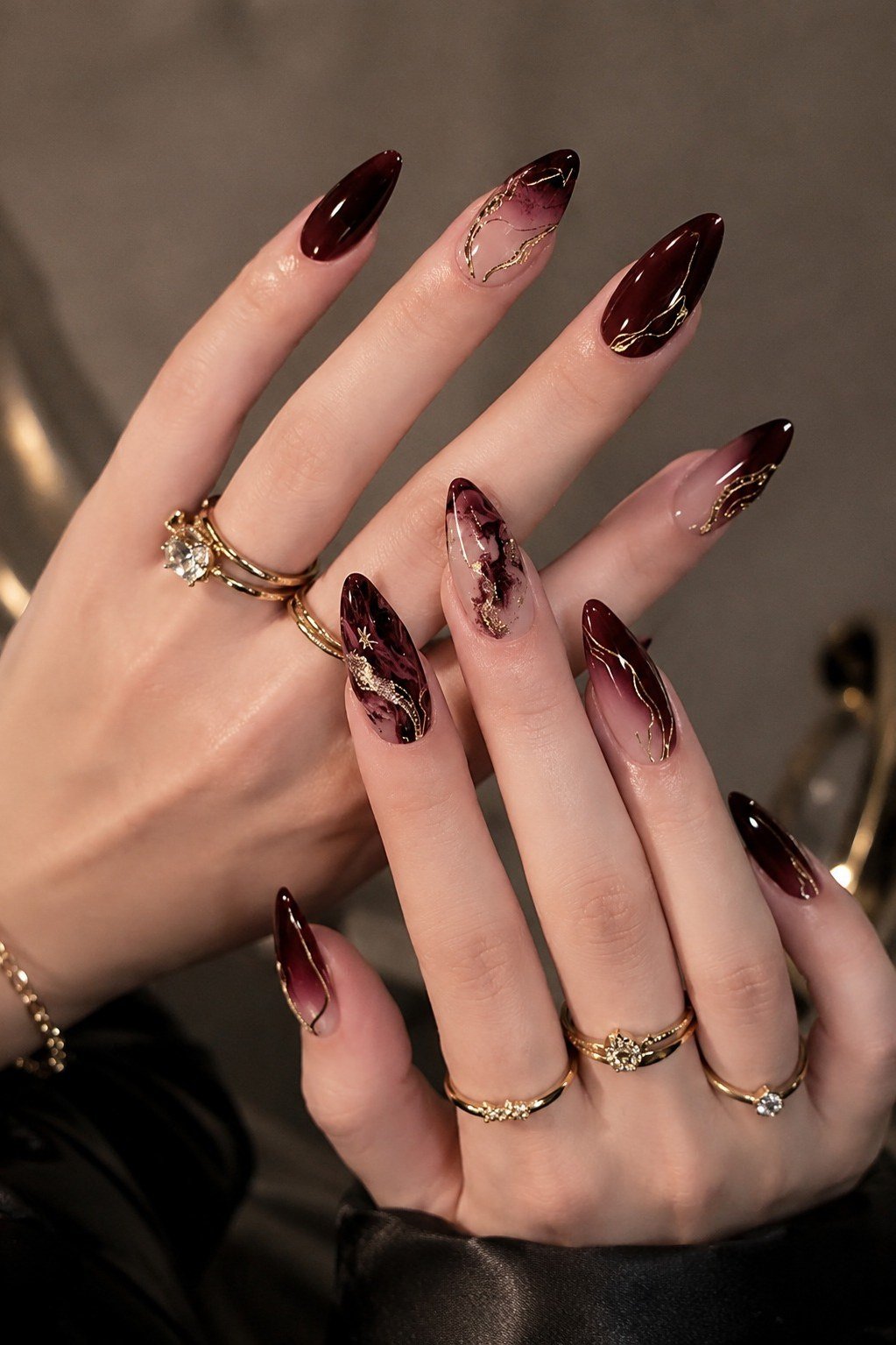 Dark burgundy nails with gold glitter tips for women over 50