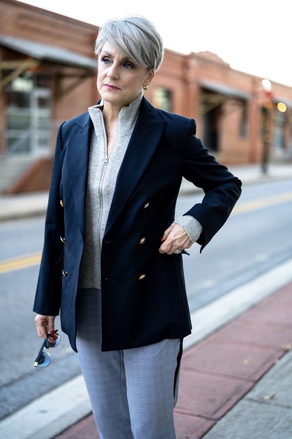 Navy blazer with striped top and grey jeans for women over 60