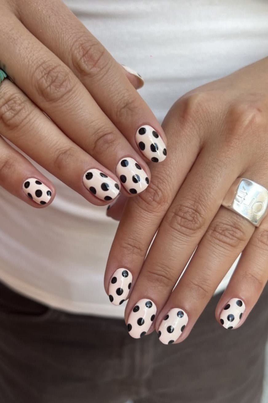 Nail art design for women over 60: black and white polka dot nail art