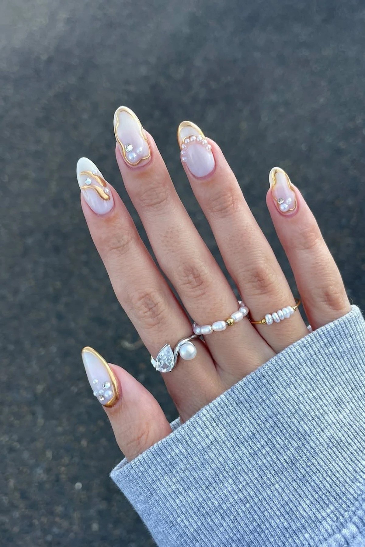 Nude nails with white marbled accent nails for women over 50