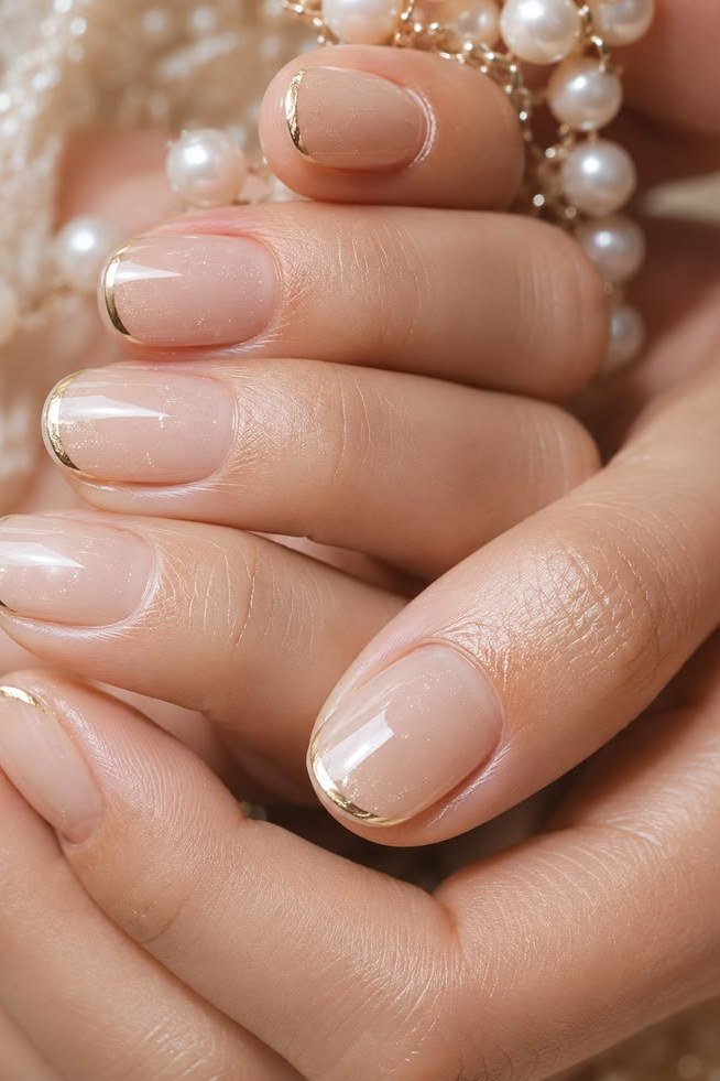 Nude nails with gold edge french tips