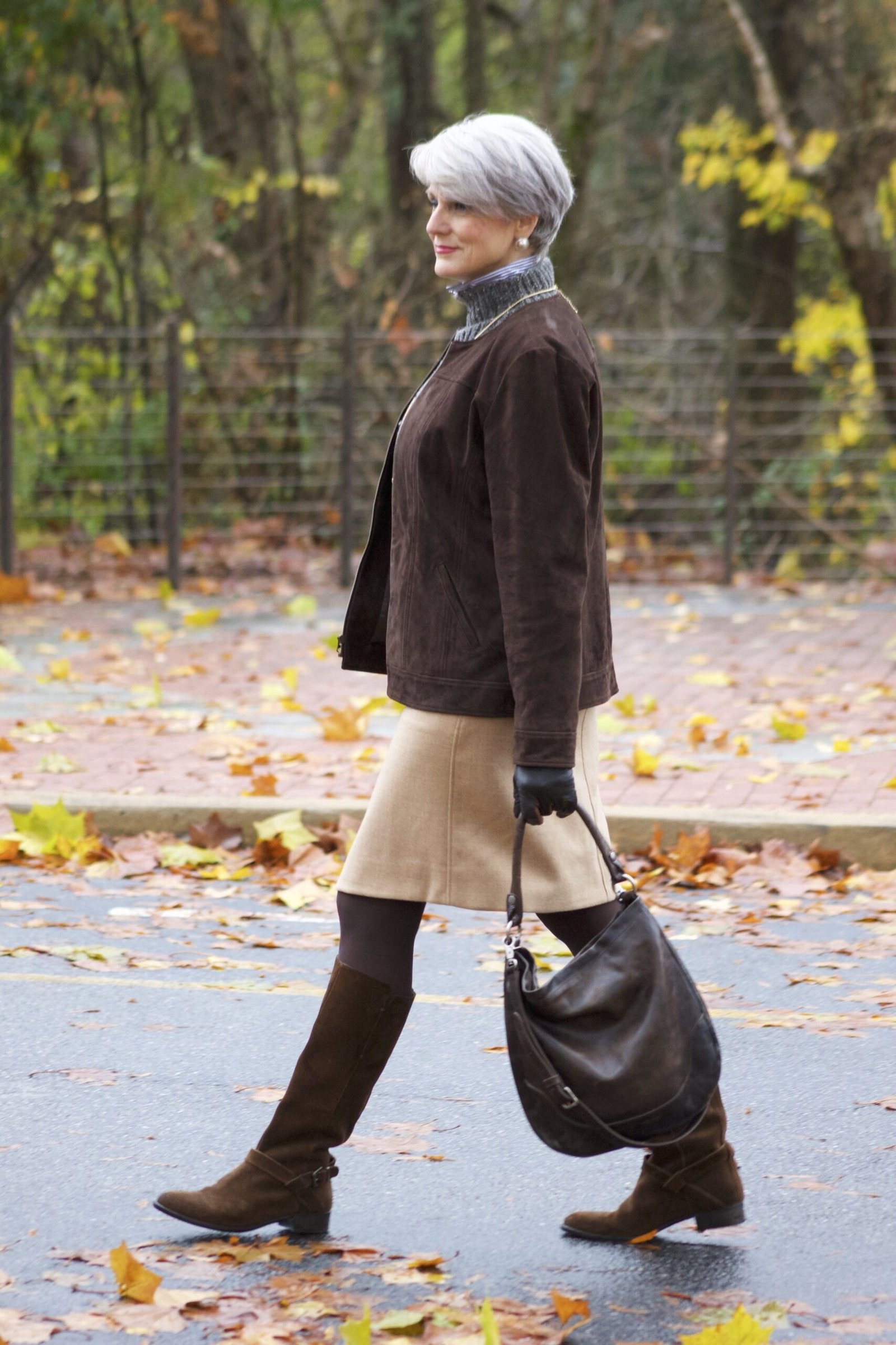 Casual fall outfit for women over 60: black ankle boots, gold jewelry, burgundy sweater, dark jeans