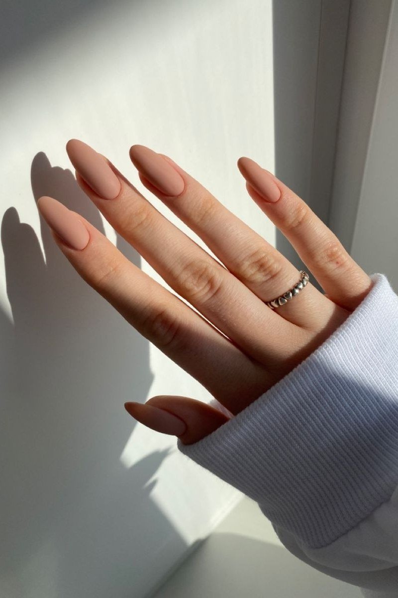 Almond nude nails in sunlight