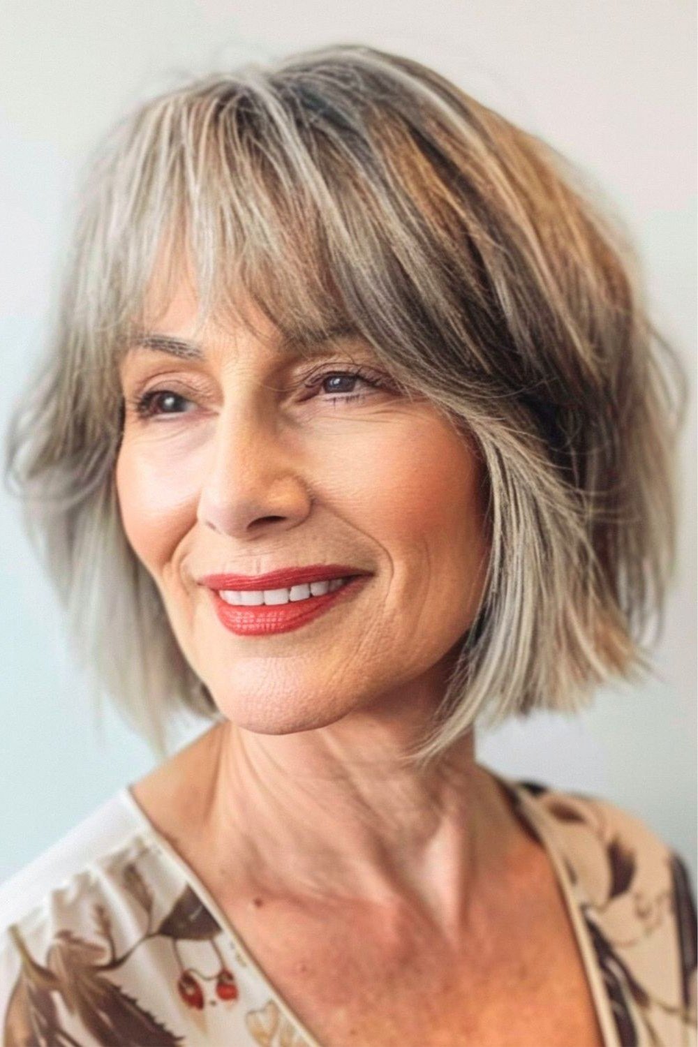 blonde-gray bob with bangs, front view, medium length hairstyle for women over 60