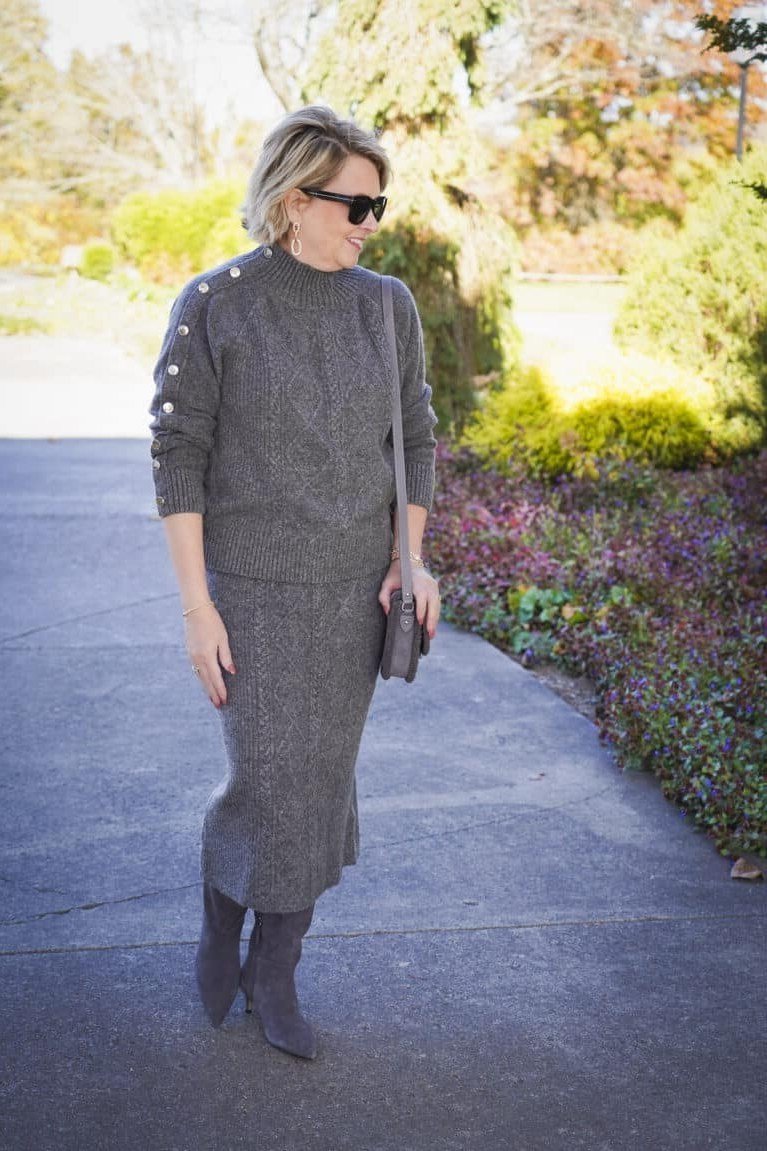 Grey knit sweater with grey midi skirt and grey knee boots