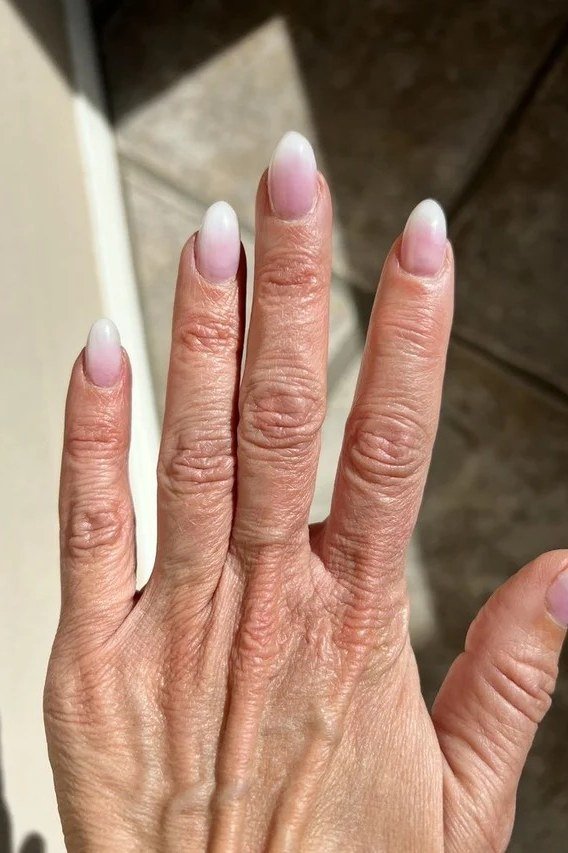 pink baby boomer fade on short square nails older hand