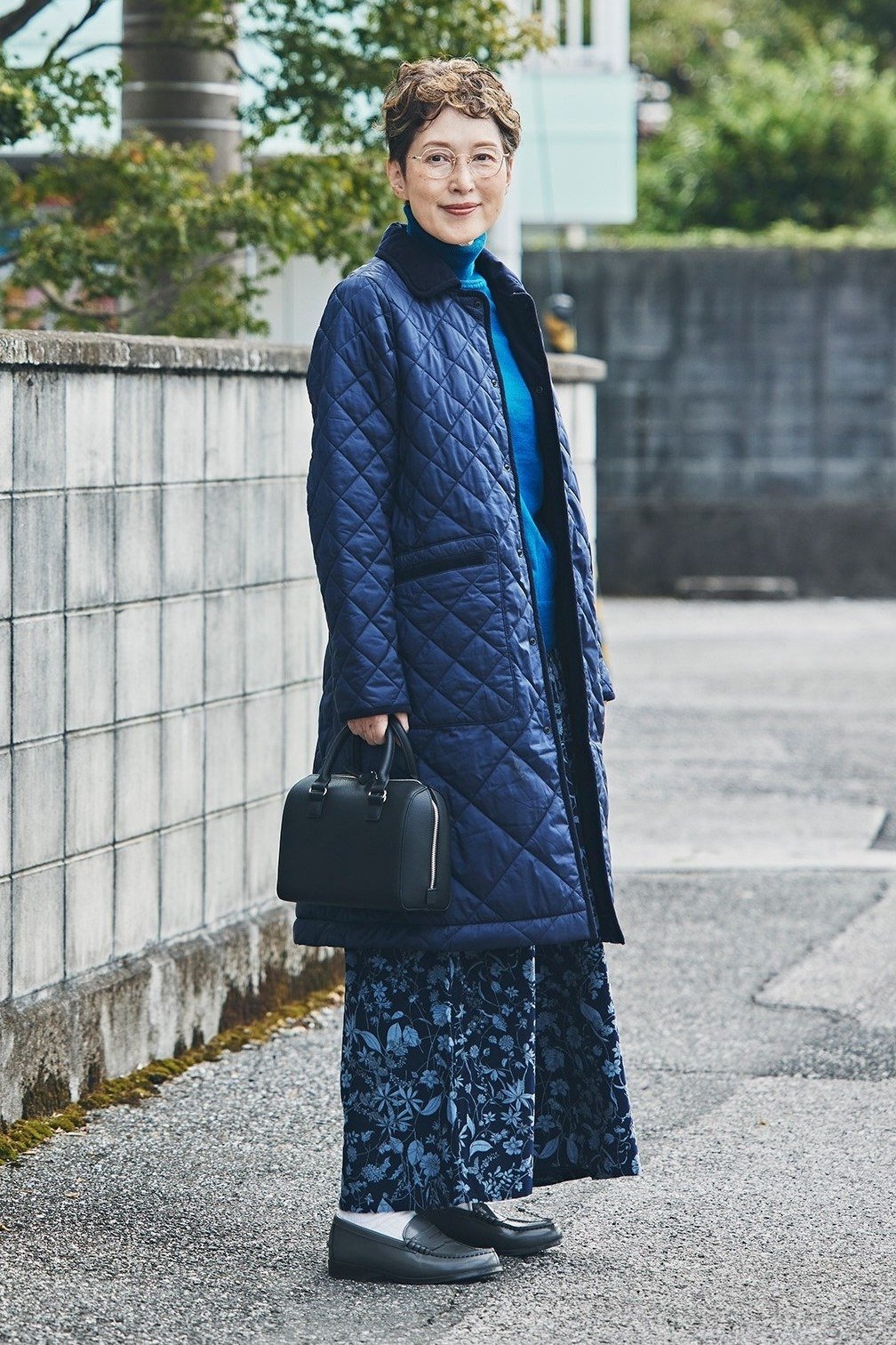 Navy quilted coat over patterned skirt outfit for women over 60