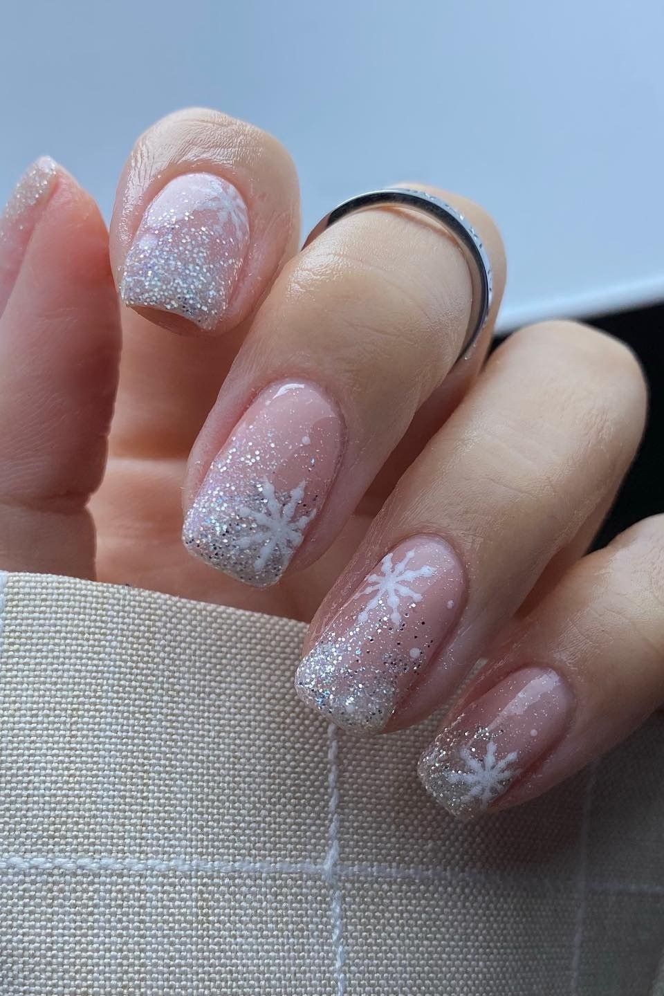 Soft Pink Glitter Ombre with Snowflakes, fun winter nail idea for women over 60