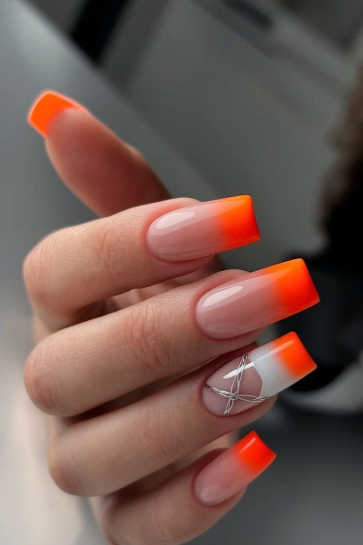 Orange French Tips with Bow Accent - Bright orange French tips pop against a sheer nude base on these medium square nails, with one accent nail wearing a tiny silver bow outline. The glossy finish keeps it playful.
