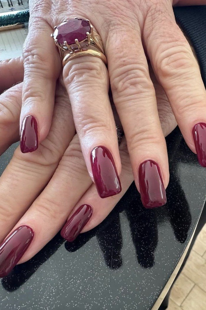 Burgundy Oval Nails with a Gemstone Ring, fall nail color idea for women over 50