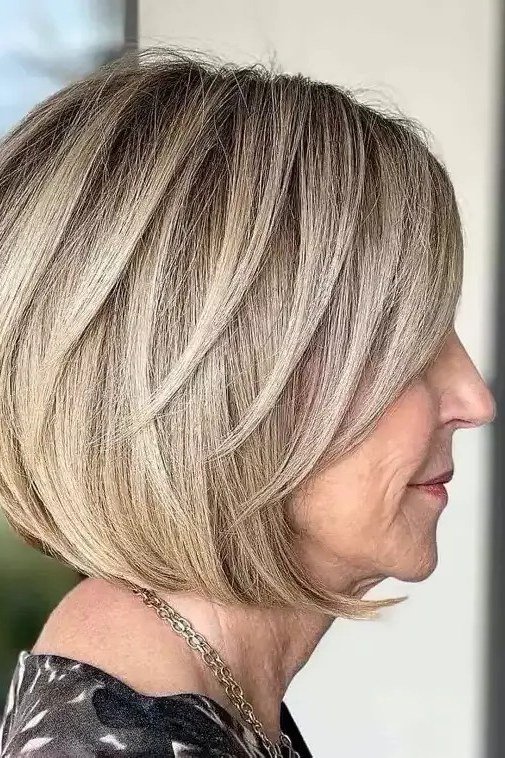 Ash blonde stacked bob side view, short layered bob hairstyle for women over 60
