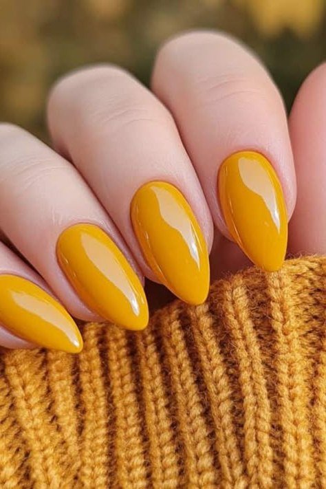 Mustard yellow solid, almond shape, medium length, glossy, mustard sweater cuff, fall nail color for women over 40